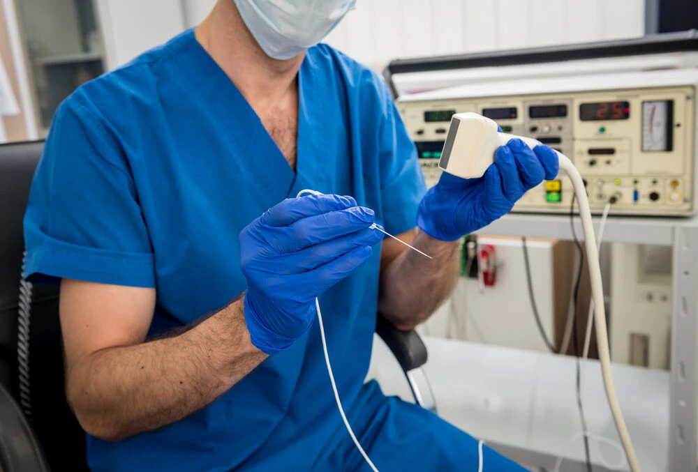 Cardiologist use tubes and ultrasound for radiofrequency catheter ablation.