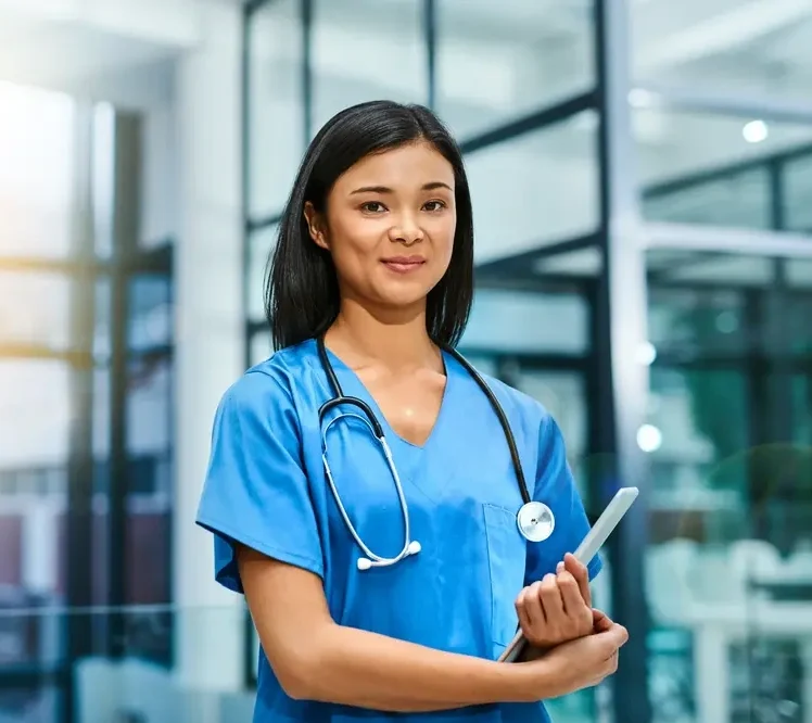 Portrait of a young nurse standing in a hospital.