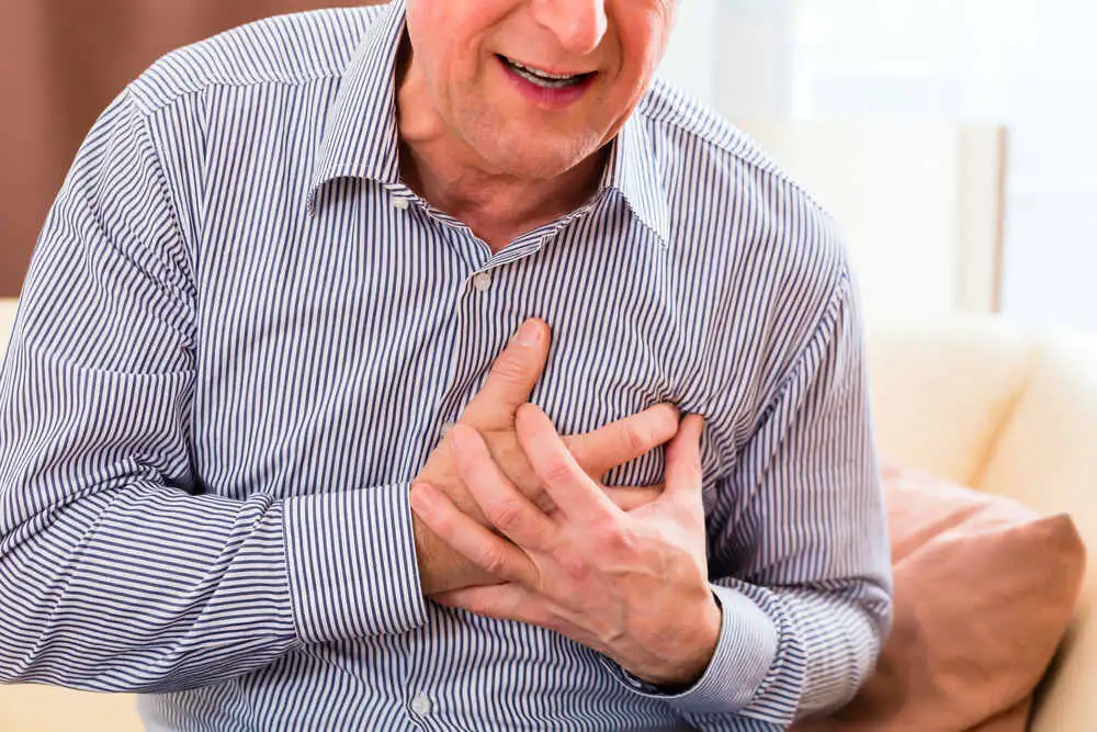 Old man holding breast because of heart infarction