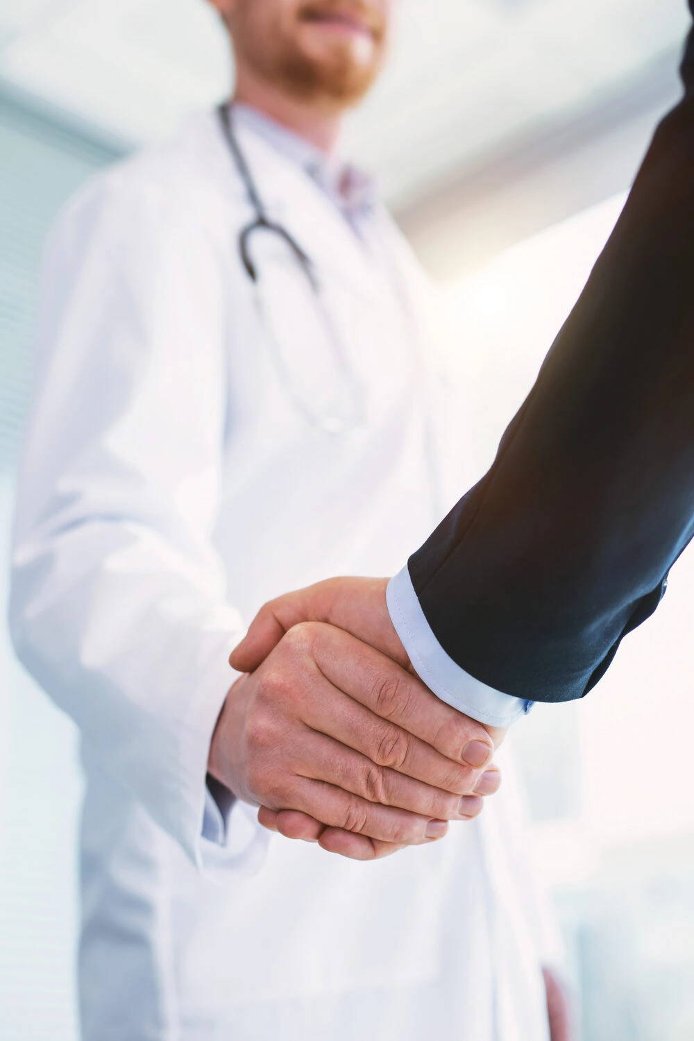 Doctor shaking hands with a patient