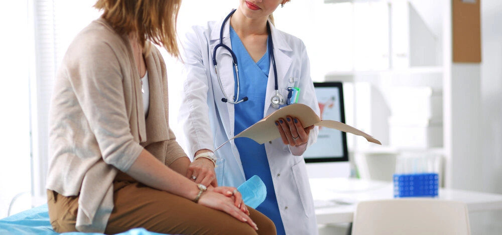 Doctor and patient discussing something while sitting at the table